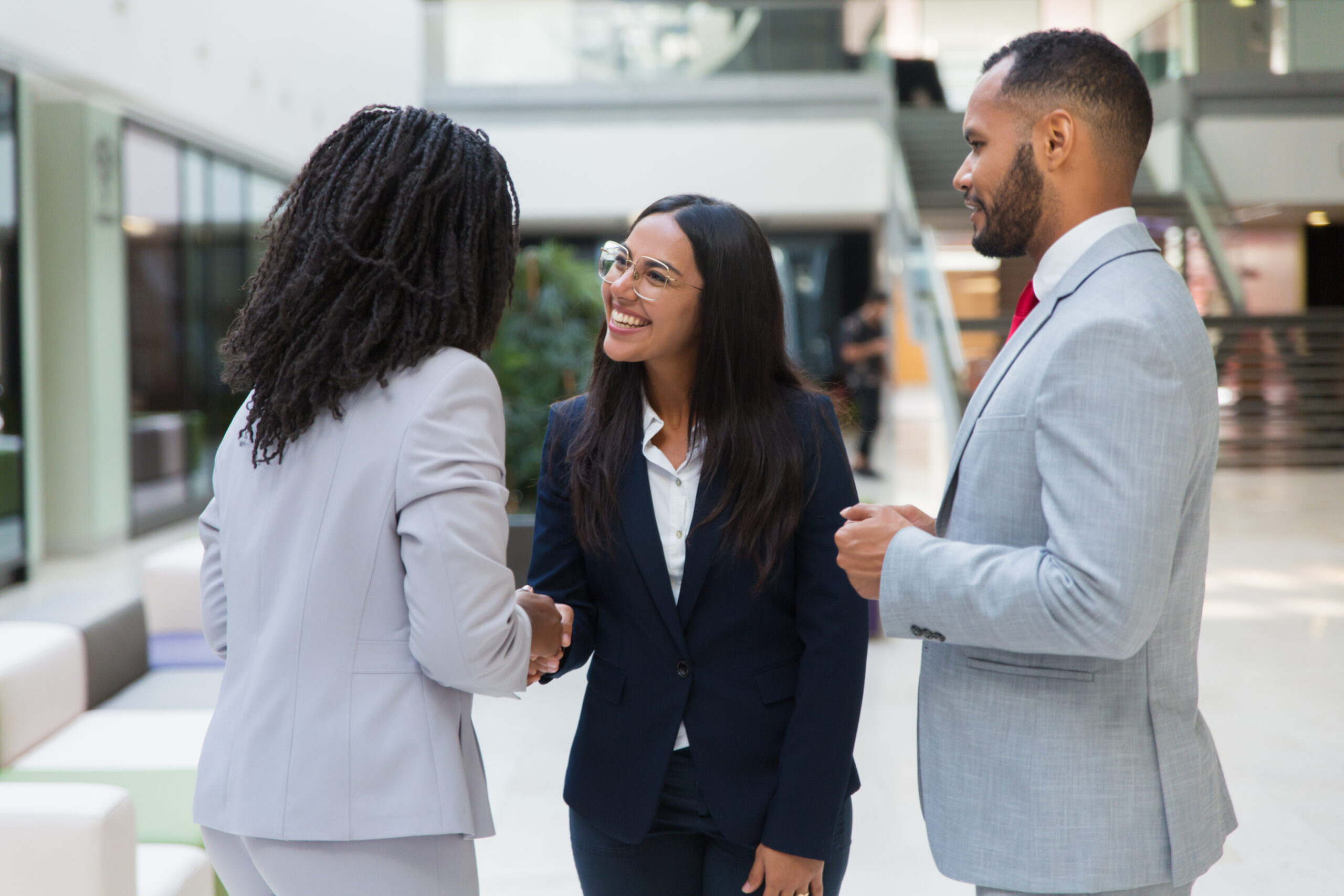 female diverse business partners shaking hands