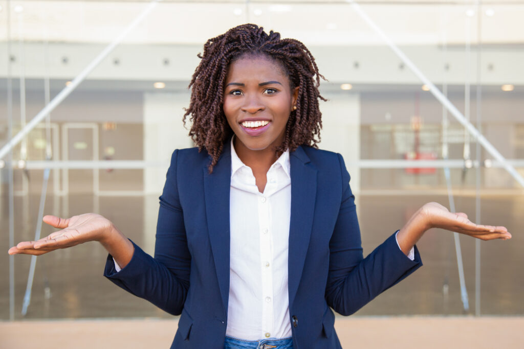 cheerful confused female manager posing outside